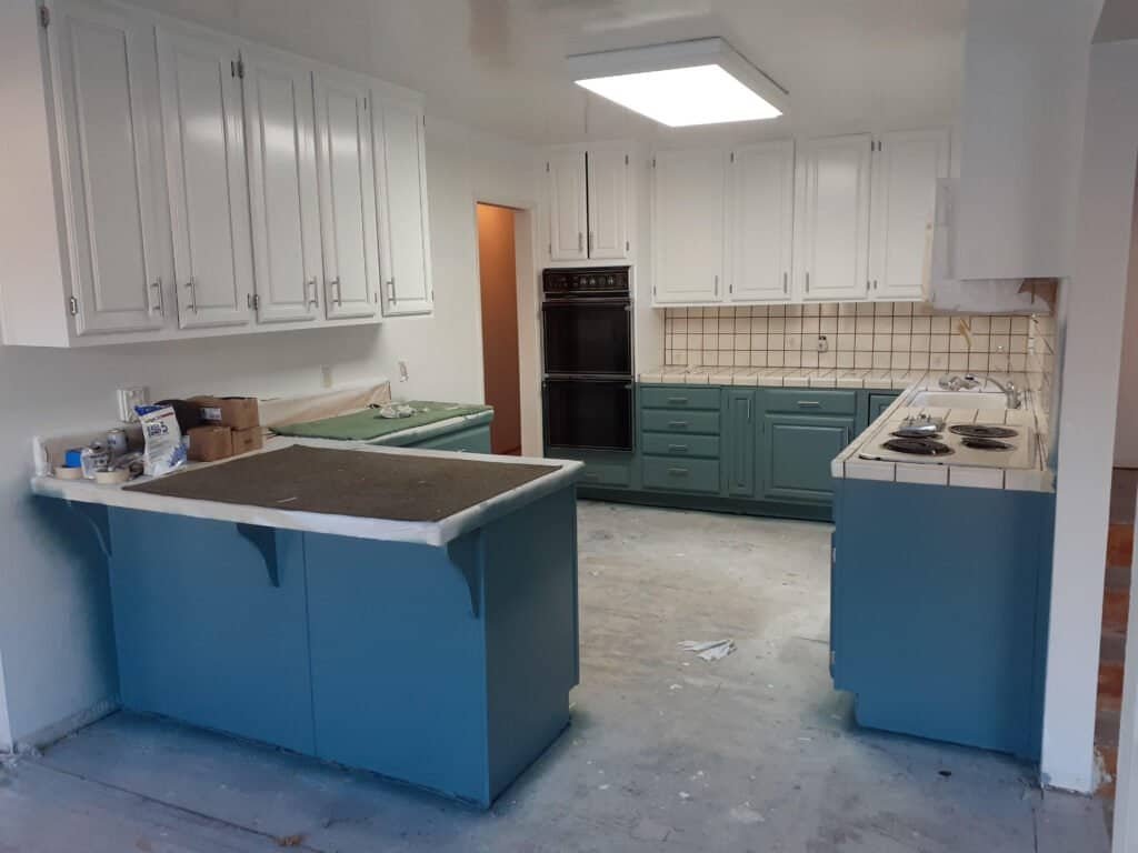 Kitchen renovation with fresh blue and white paint by True Solutions Painting.
